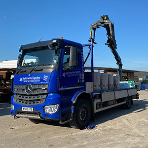 Natiionwide Supplies lorry with crane loaded with bricks for delivery
