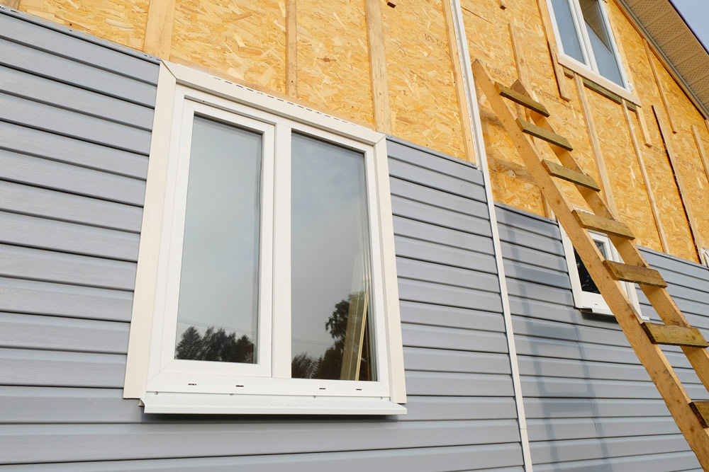 The outside wall of a house in the process of being cladded.